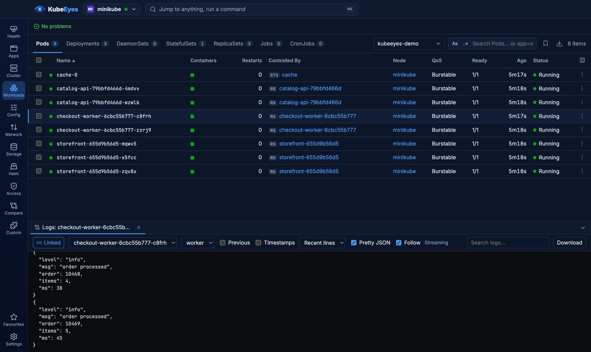KubeEyes showing a namespace's pods with a pretty-printed JSON log stream docked below